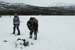 Two team members standing in the snow.