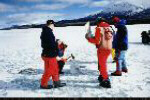 Meteorite recovery team around ice block containing meteorite fragments.