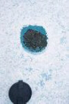 Meteorite fragment resting just below the surface of the ice.