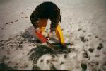 Phil McCausland cutting into ice with chain saw to recover meteorite fragments.