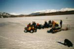 The team near their ATVs and snowmobile.